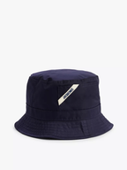 A navy blue bucket hat with a wide brim and a white brand tag embroidered on the front.