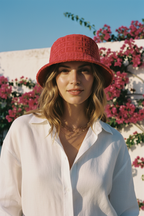 Woman wearing a red bucket hat with a floral background