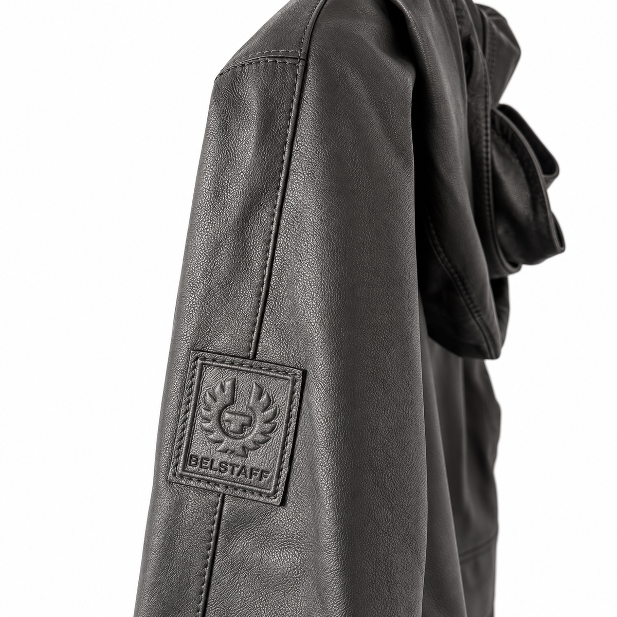 Close-up of Belstaff Black Hooded Leather Jacket sleeve featuring a square Belstaff logo patch on the upper arm, set against a plain white background.