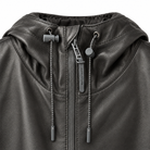 Close-up of a black faux-leather hooded jacket with a front zipper, drawstrings, and a visible BELSTAFF brand tag on the zipper pull.
