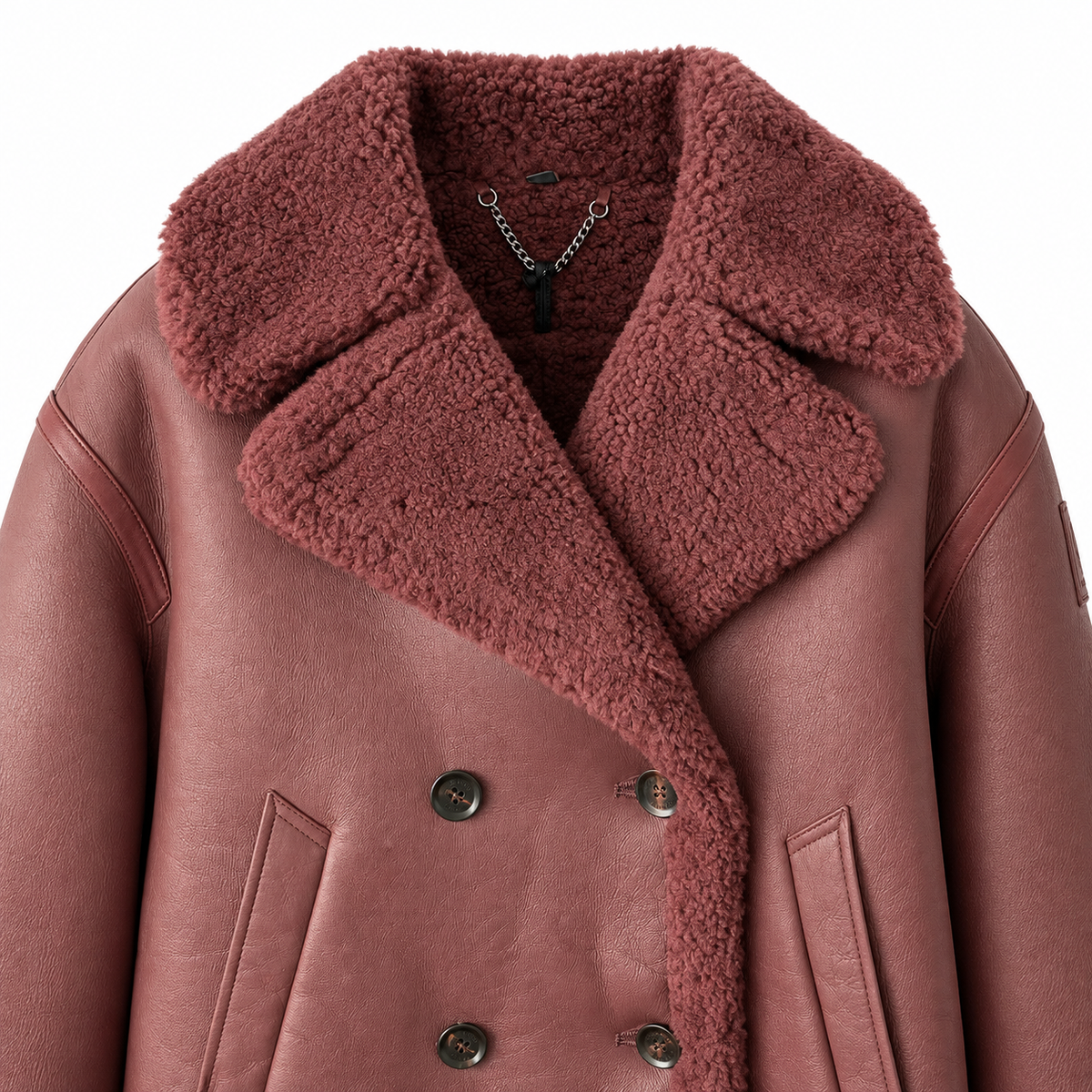 A close-up of a dusty rose shearling-lined jacket with a matching shearling collar, double-breasted with dark buttons, on a white background.