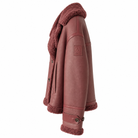 Belstaff Cedar Shearling Leather Jacket A side profile view of a dusty rose shearling-lined jacket, showing the smooth leather exterior, button closure, and matching fleece lining on a solid white background.