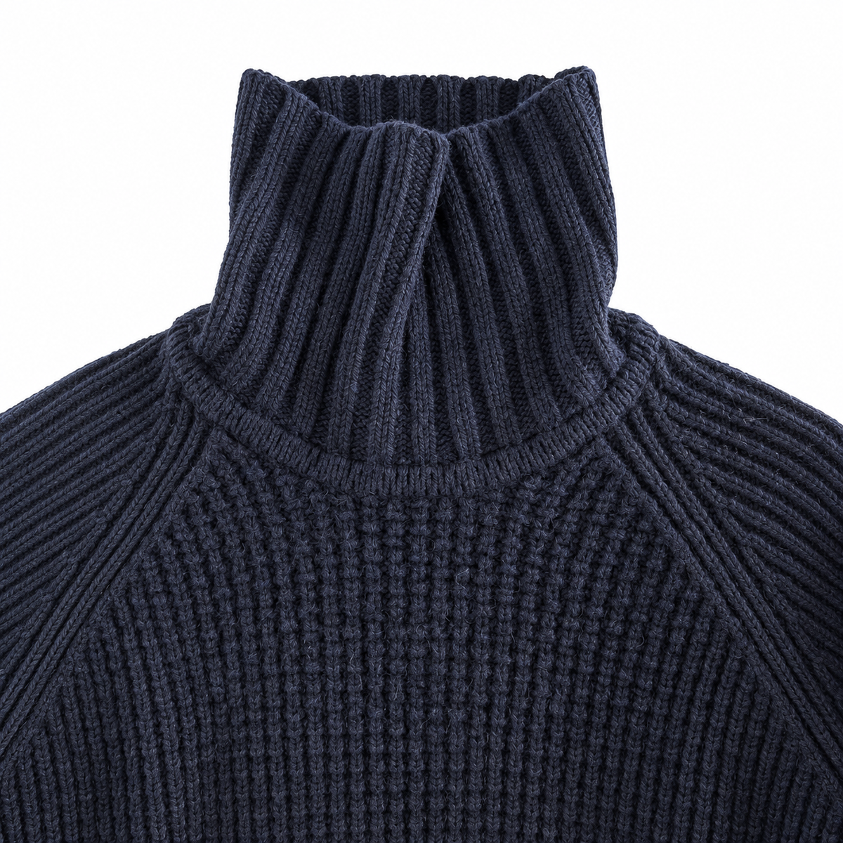 Close-up of a dark navy ribbed knit turtleneck sweater showing the high collar and textured knit pattern against a plain white background.