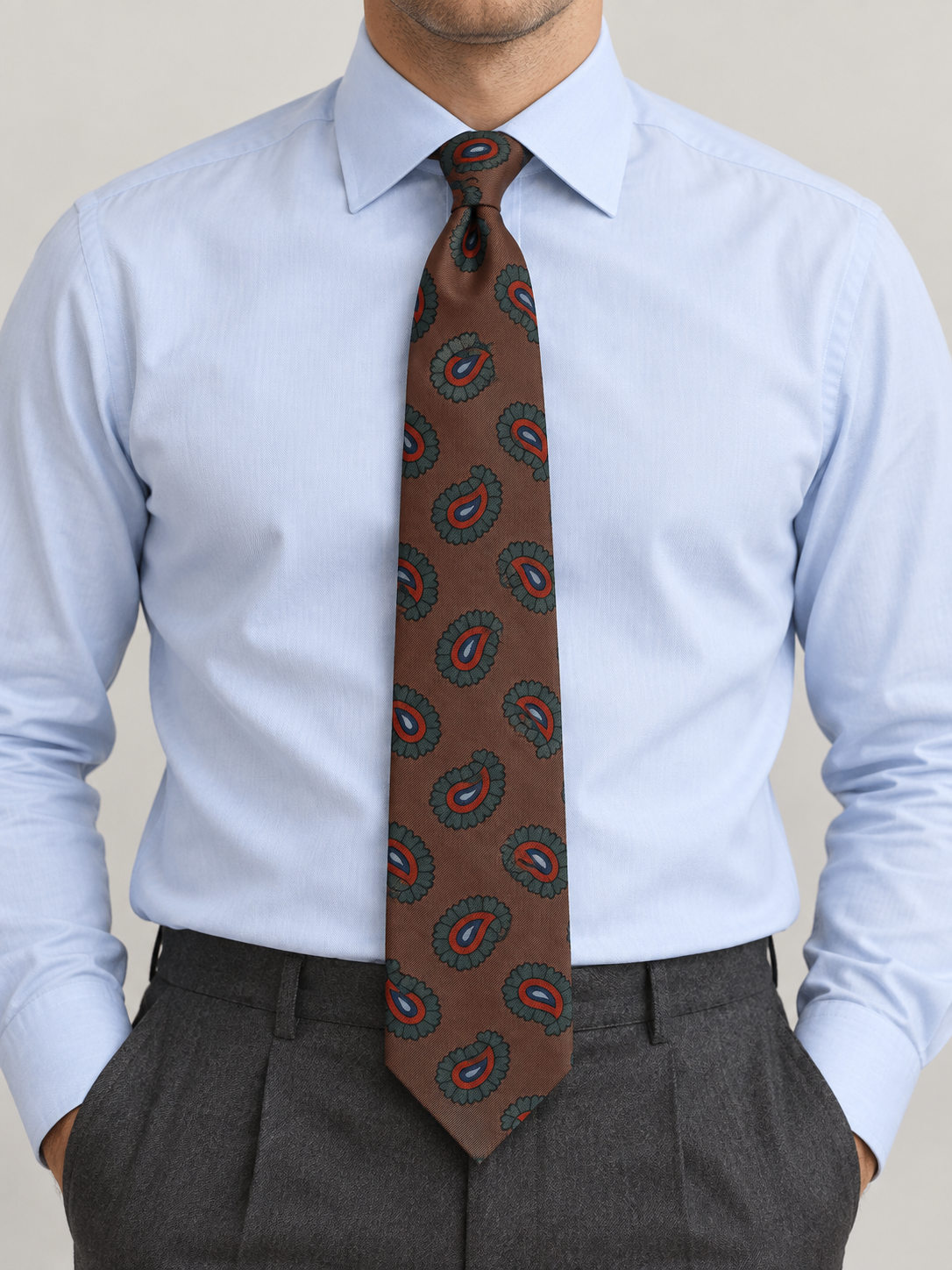 Drake’s Michael J Drake Brown Paisley Print Tie on blue shirt