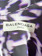 Balenciaga label on a garment with a purple and black patterned background