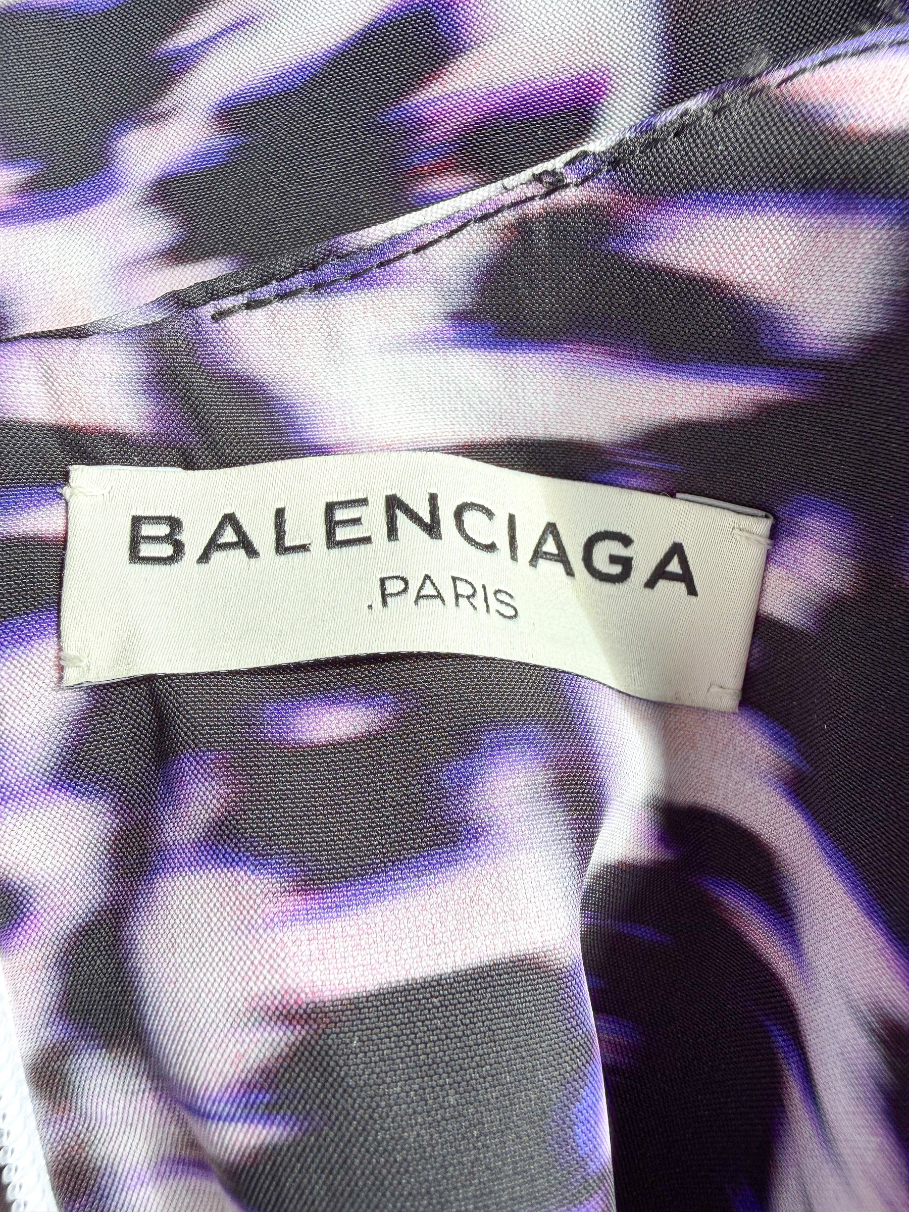 Balenciaga label on a garment with a purple and black patterned background