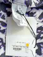 Close-up of clothing tags with a patterned fabric background
