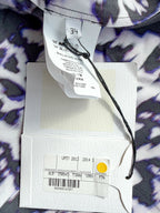 Close-up of clothing tags with a patterned fabric background