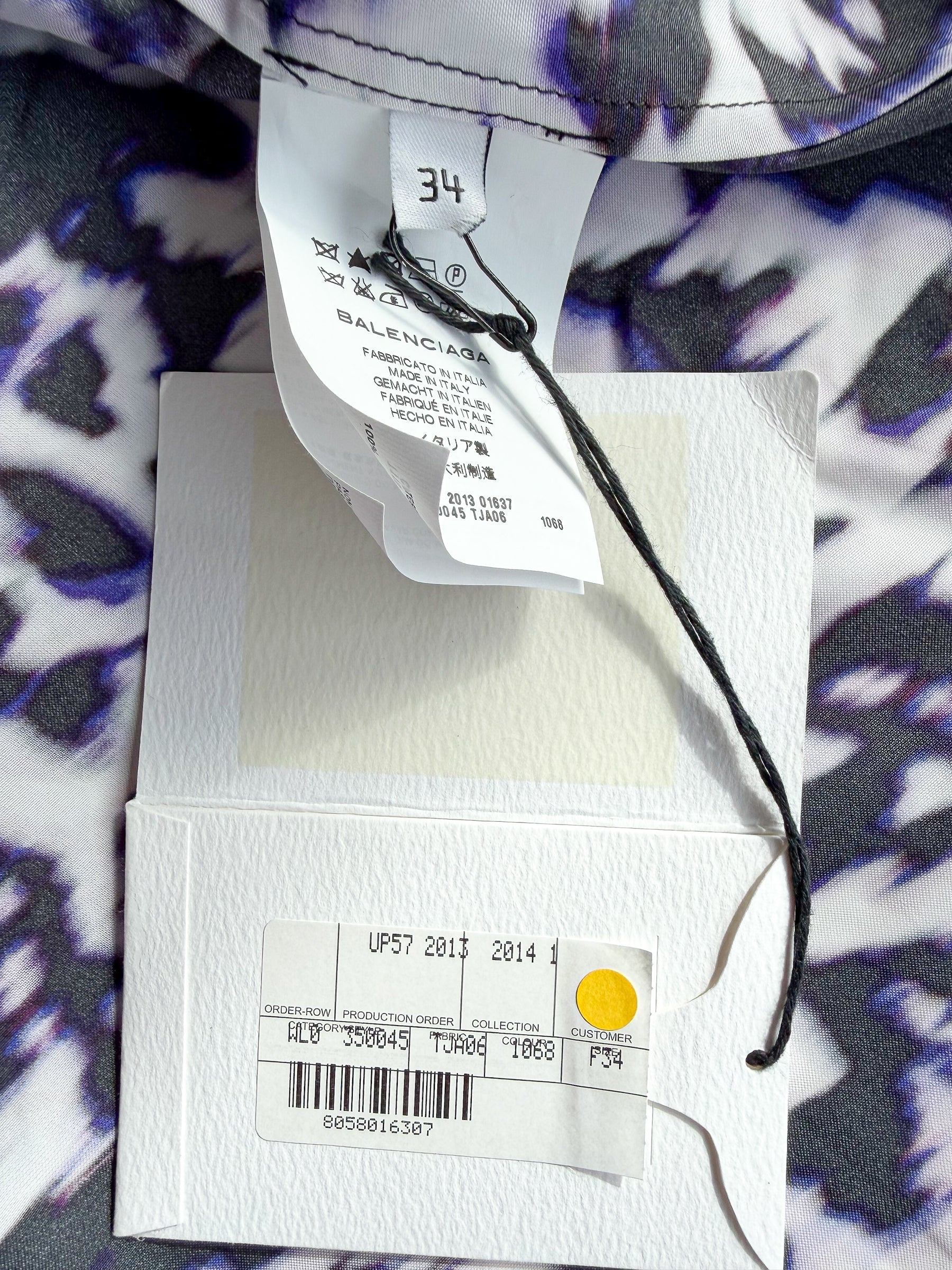 Close-up of clothing tags with a patterned fabric background