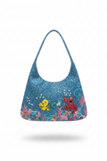 Blue beaded handbag with the little mermaid animation flounder and sebastian characters on a white background