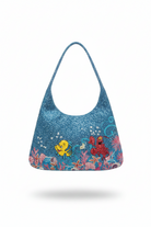 Blue beaded handbag with the little mermaid animation flounder and sebastian characters on a white background