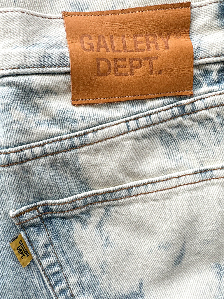 Close-up of a denim fabric with a 'GALLERY DEPT.' leather label.