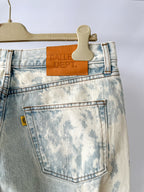 Blue acid-wash jeans on a hanger with 'Galle Dept.' label.