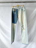 Gallery Dept Pair of light blue jeans on a hanger against a white background