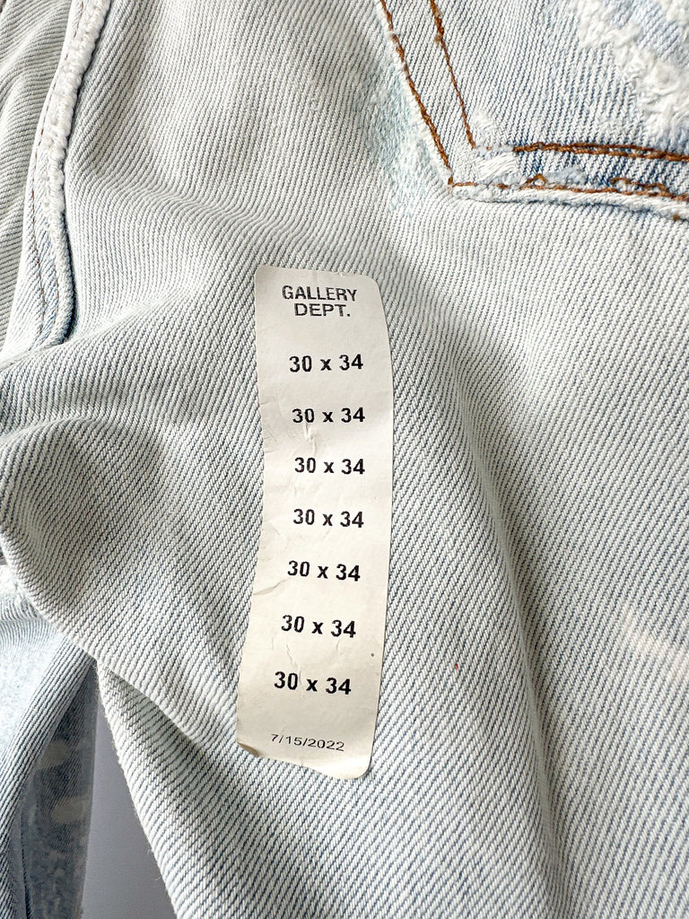 Measurement label on a denim garment with 'Gallery Dept.' branding.
