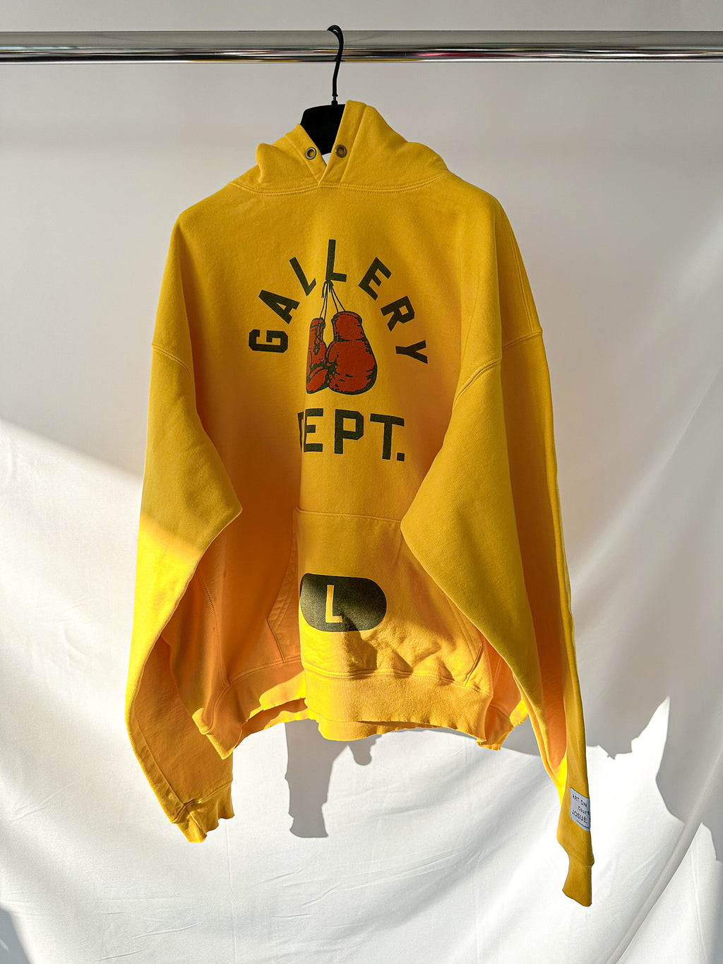 Gallery Dept Yellow hoodie with graphic design on a white background