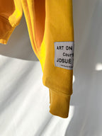 Gallery Dept Yellow hoodie with graphic design on a white background