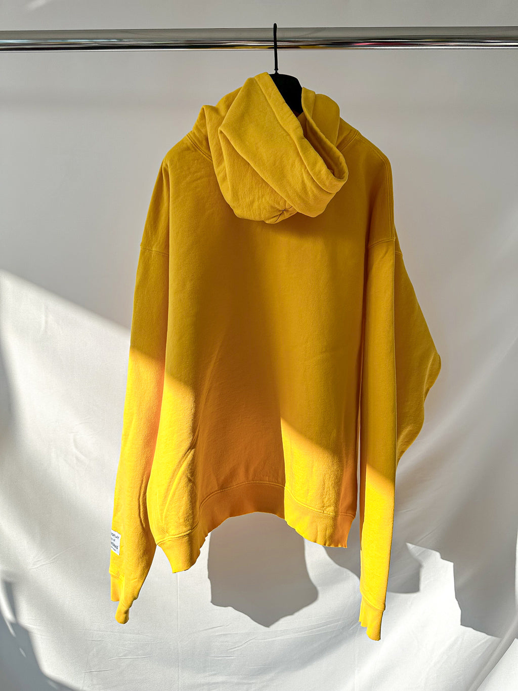 Gallery Dept Yellow hoodie with graphic design on a white background