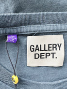 Label on a garment with 'GALLERY DEPT.' text and a purple tag.