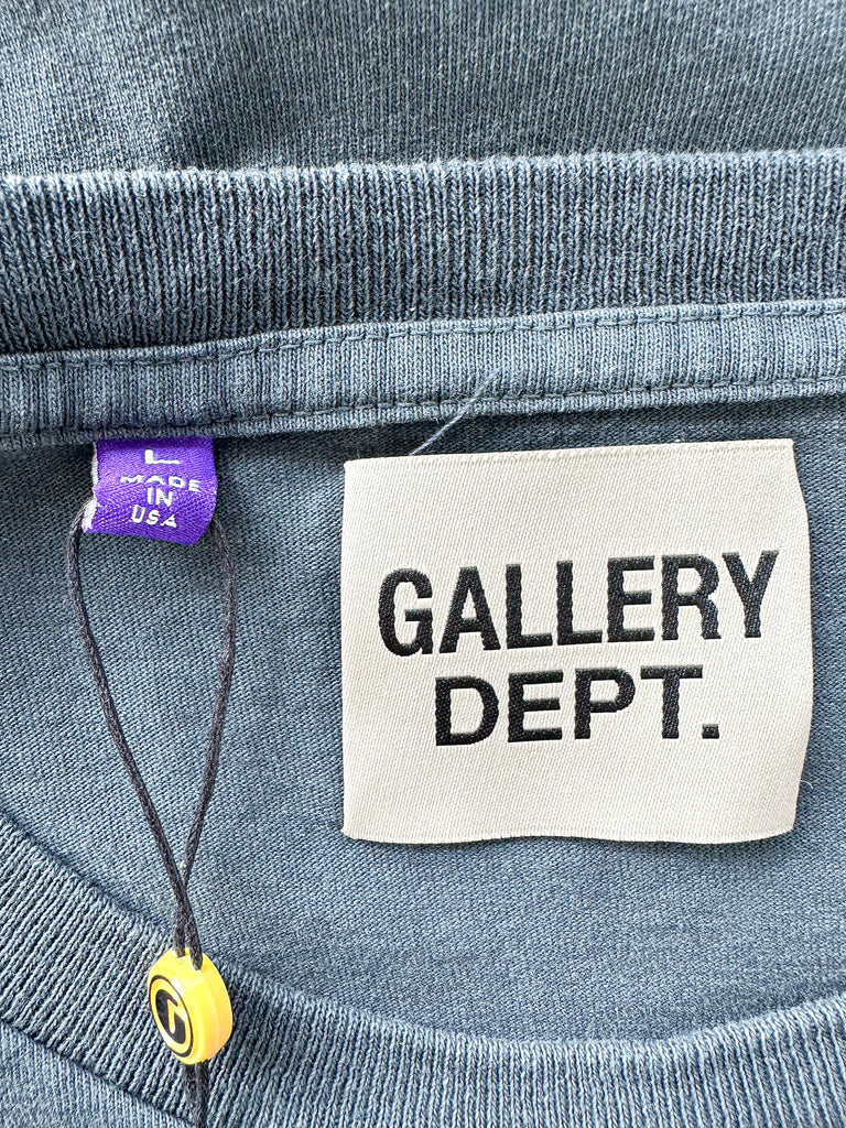 Label on a garment with 'GALLERY DEPT.' text and a purple tag.