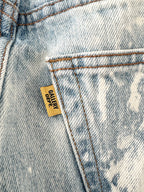 Close-up of a denim pocket with a 'GALLERY DEPT.' label.