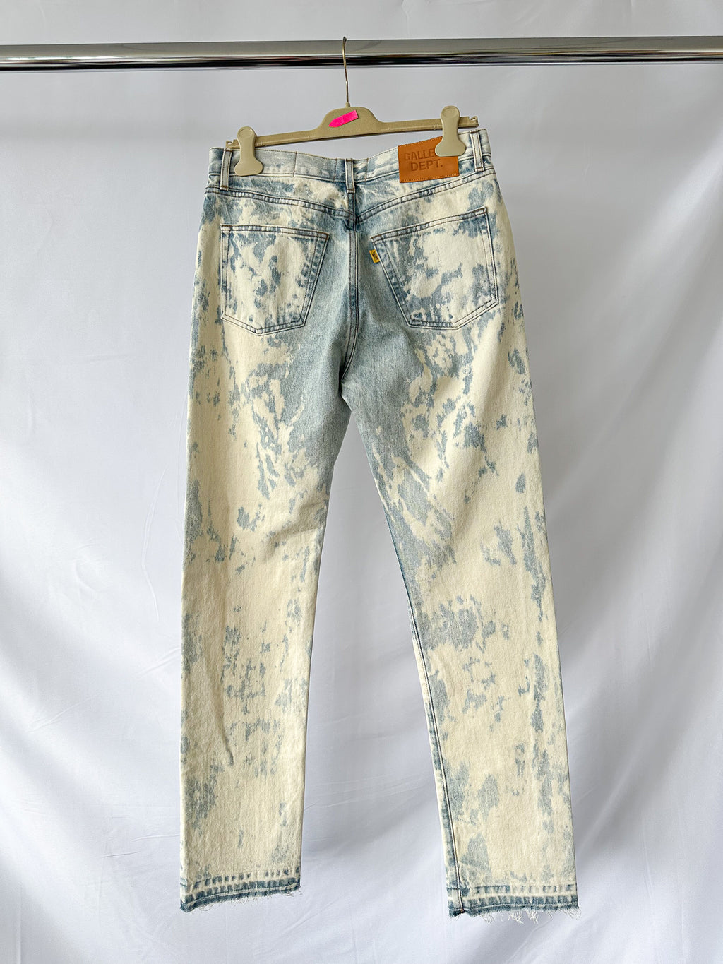 Gallery Dept Levi 501 idstressed white jeans on a hanger against a white background