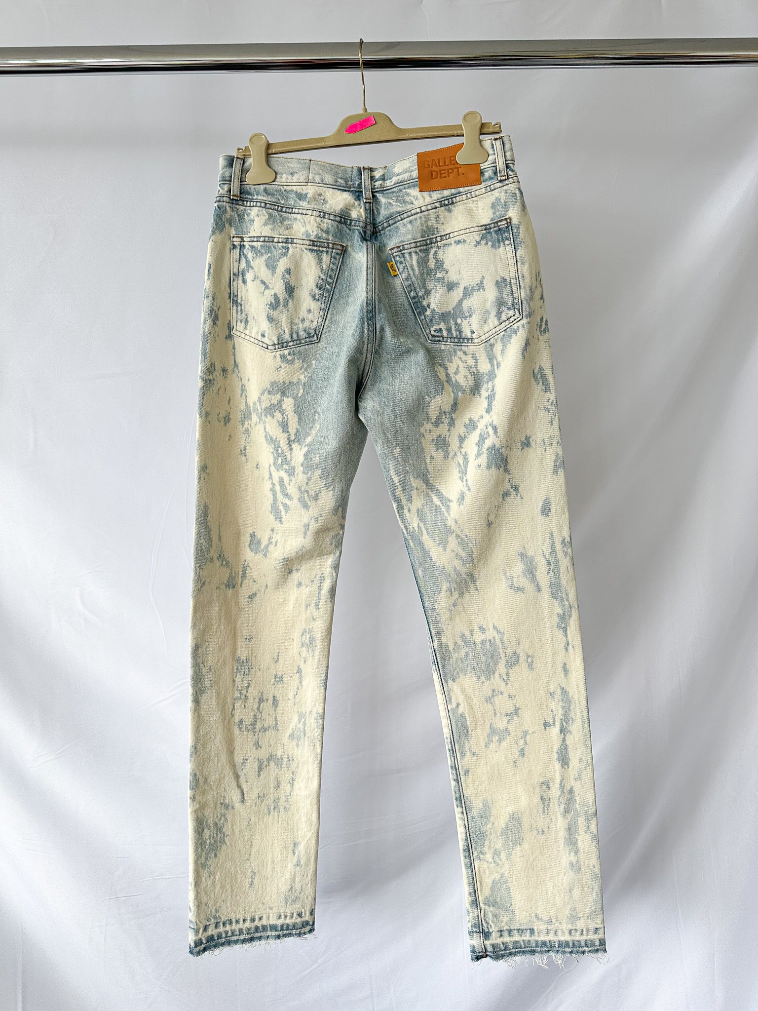 Gallery Dept Levi 501 idstressed white jeans on a hanger against a white background