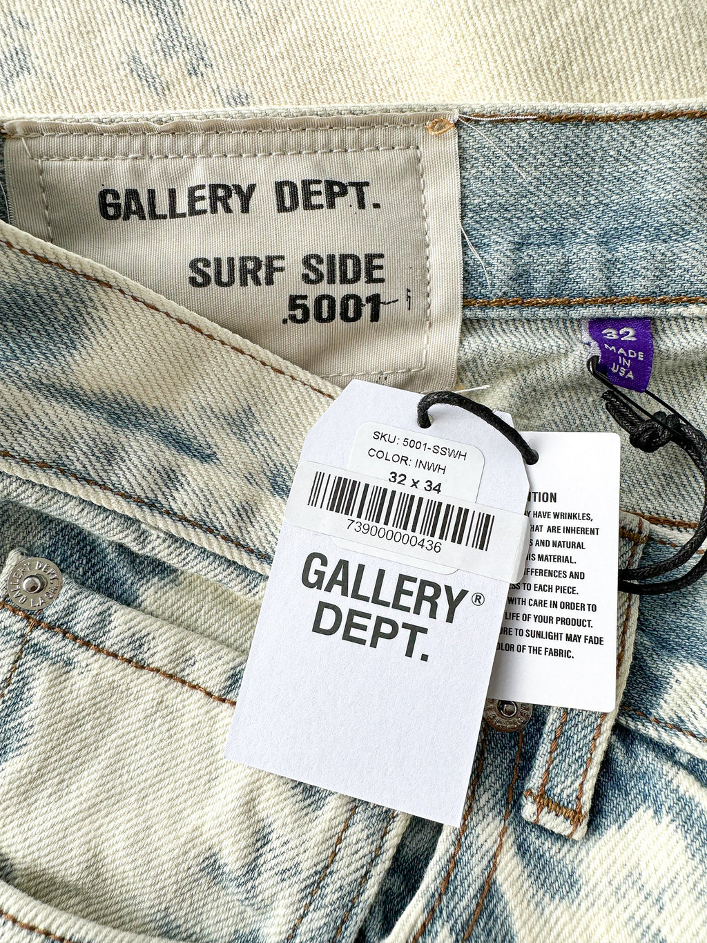 Close-up of Gallery Dept. denim with brand labels and size information.