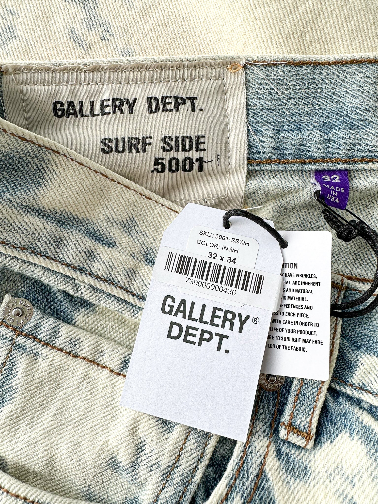 Close-up of Gallery Dept. denim with brand labels and size information.