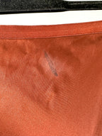 Close-up of a brown leather surface with a visible scuff mark.