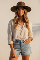 Brown fedora hat with a wide brim on a white background