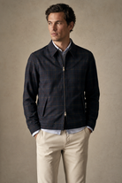 Man wearing Drake's Waxed Madras Tennis Blouson Jacket in navy blue