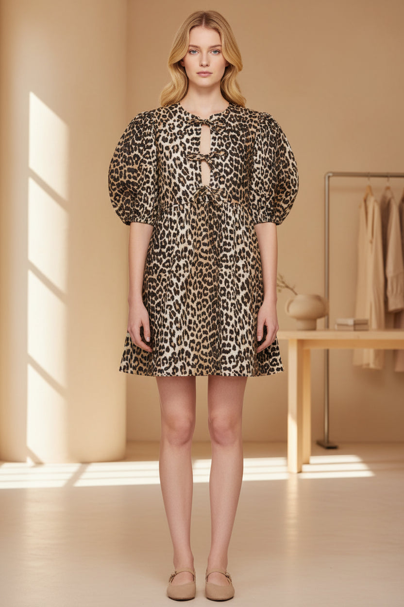 Model wearing a leopard print dress with puff sleeves against a neutral background