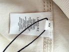 Close-up of a Lemaire label on beige fabric