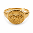 A gold signet ring featuring an engraved ram's head and the word 'Aries' on the oval face, set against a plain white background.
