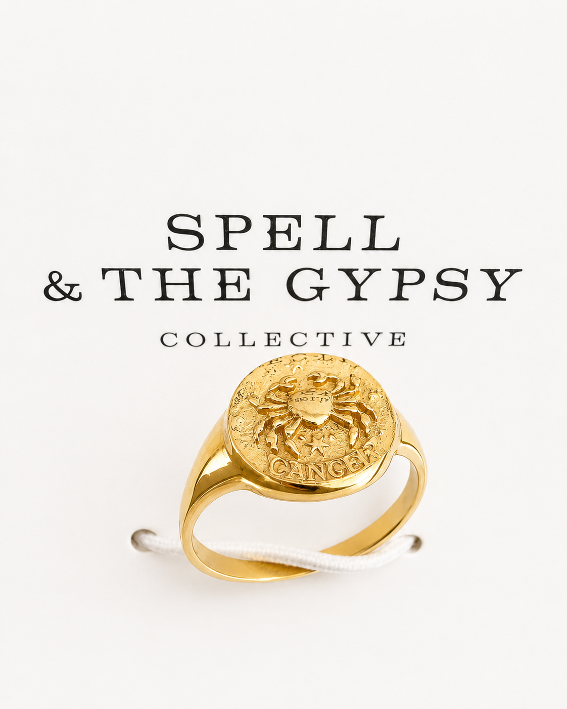 A gold signet ring with a raised circular face featuring a zodiac symbol and the word 'Cancer,' displayed against a white background with the text 'SPELL & THE GYPSY COLLECTIVE' above it.